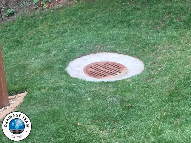 24 inch Round in Lawn | Basement Waterproofing Company