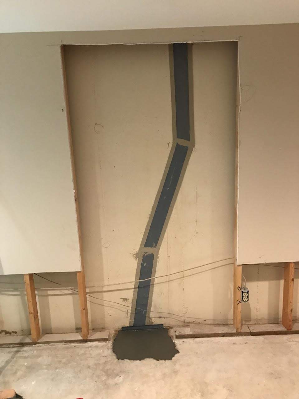 Exposed wall with sealed vertical foundation crack