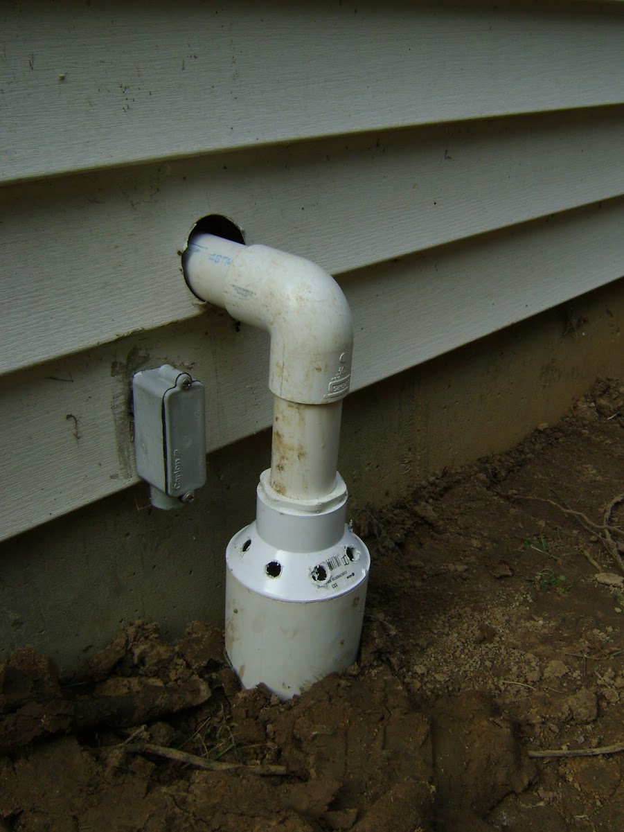 PVC vent pipe exiting house foundation wall