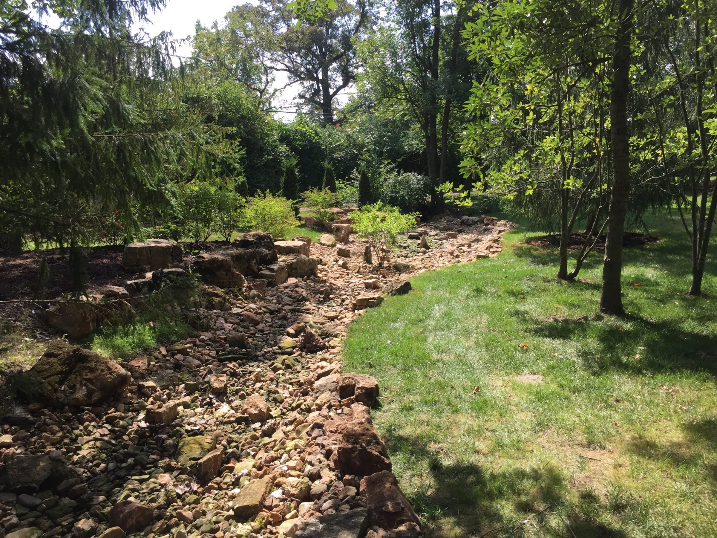 Landscaped garden with rocky dry creek bed