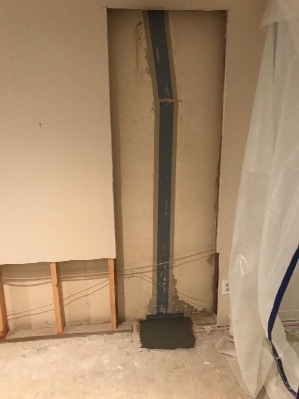 Exposed wall with steel beam and patch repair