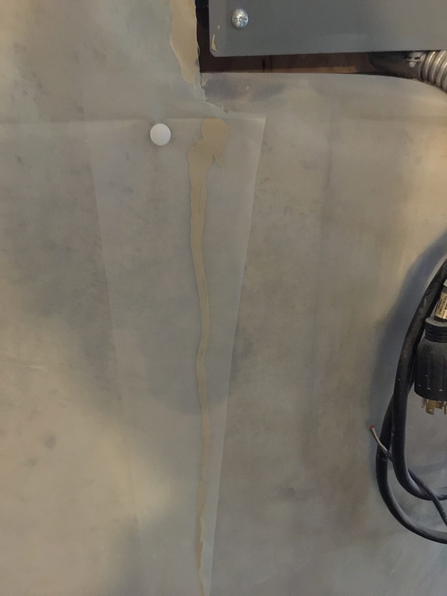 Water stain dripping down cabinet panel