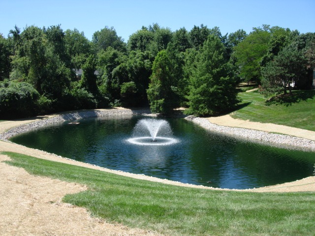 Small landscaped pond with central fountain