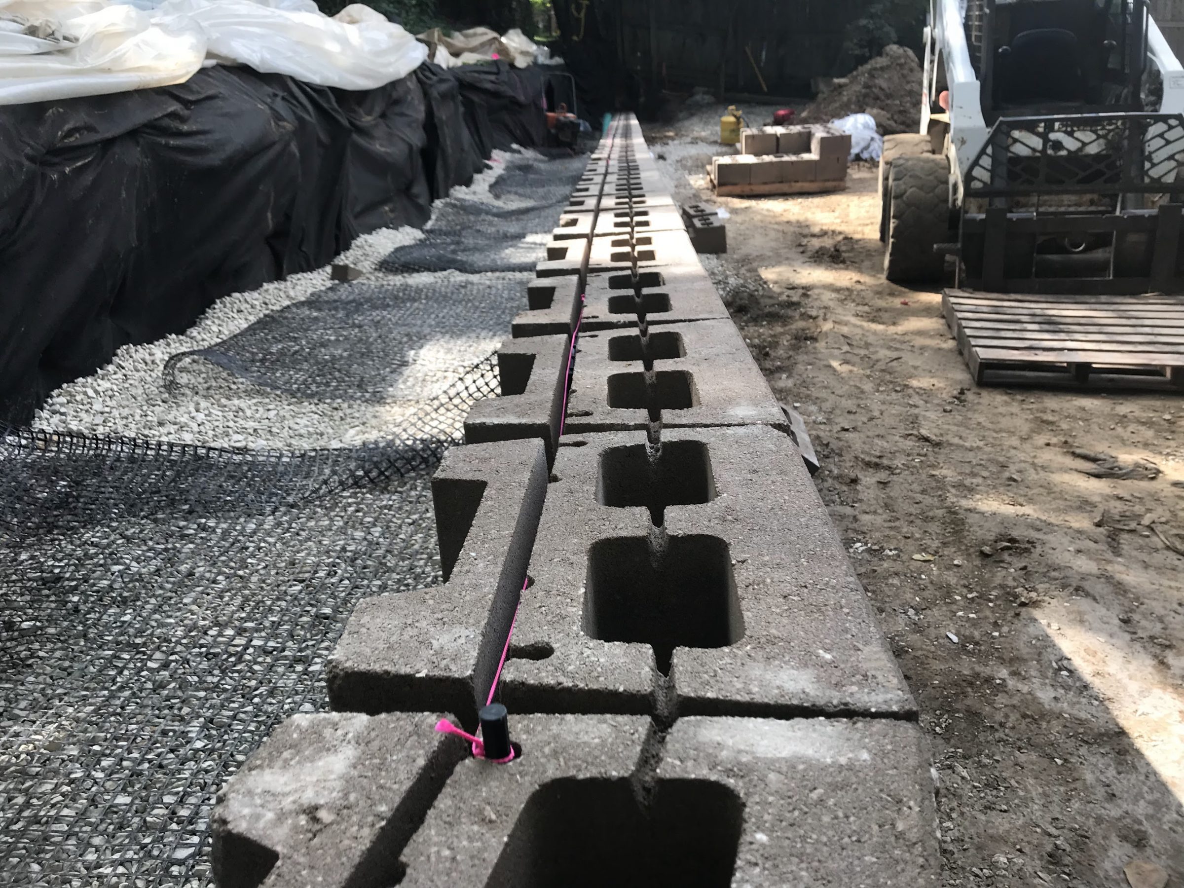 Cinder blocks aligned for retaining wall construction