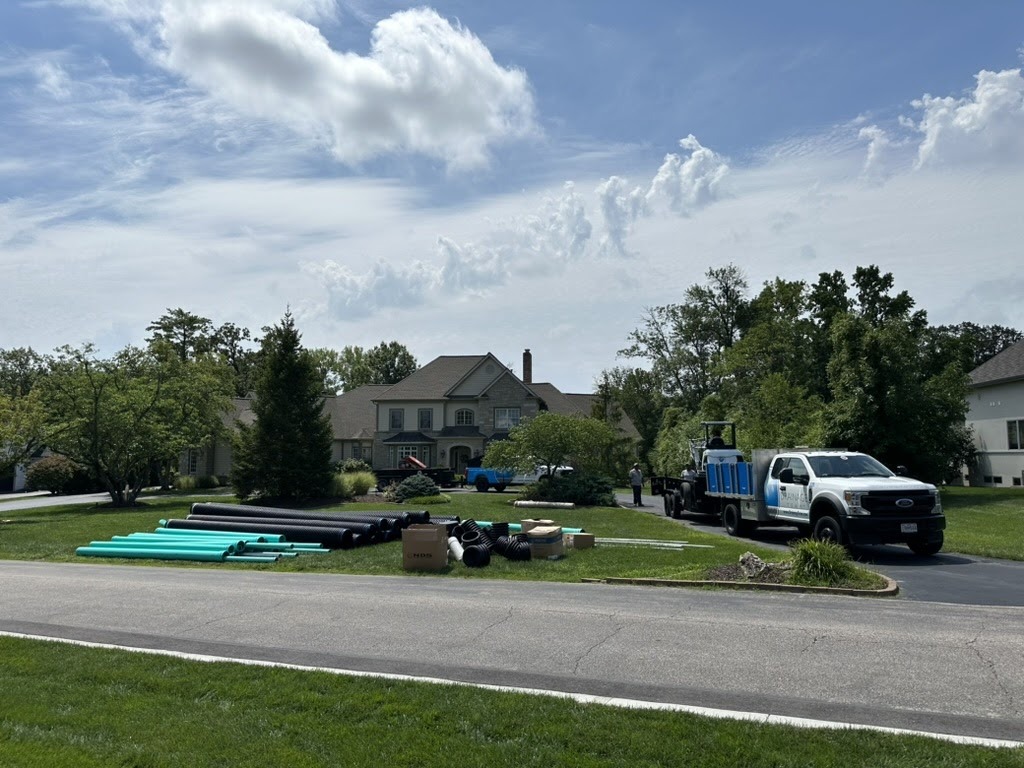Suburban home with trucks and construction materials outside
