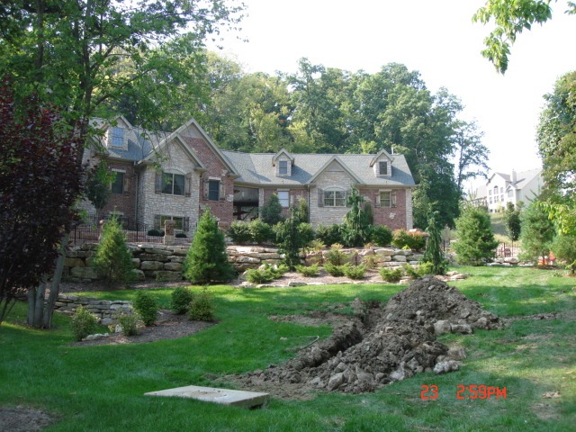 Suburban brick house with dug trench in lawn